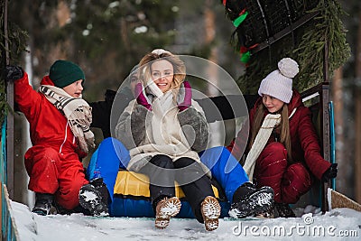 Parents bought their children tubing and now the whole family ride down the ice slide Stock Photo