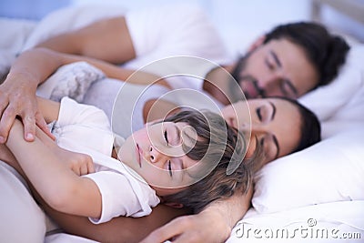 Parents, boy and sleeping in bedroom, home and embrace for rest, peace and quiet with bonding. Father, mother and child Stock Photo