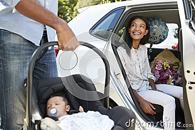 Parents Bringing Newborn Baby Home In Car Stock Photo