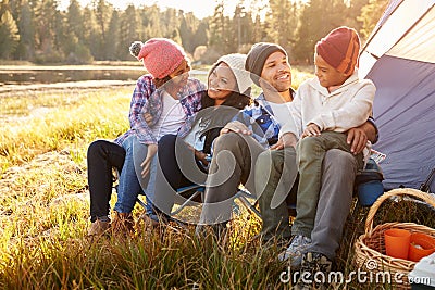 Parents With Children Camping By Lake Stock Photo