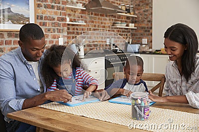 Parents And Children Drawing On Whiteboards At Table Stock Photo