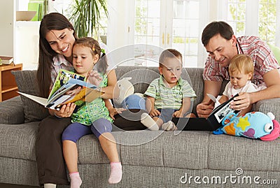 Parents and children having fun at home Stock Photo