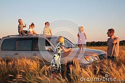 Parents and children on offroad car on wheaten fie Stock Photo
