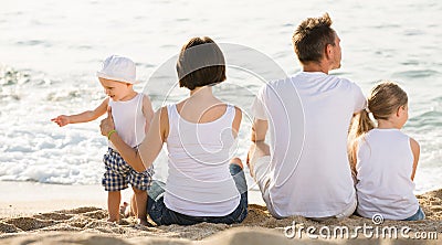 Parents with children sitting with back forward Stock Photo