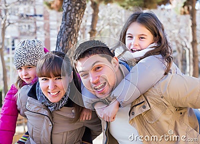 Parents with children walking through park Stock Photo