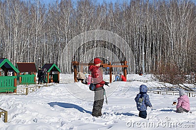 Parents with children are walking in the winter park. Editorial Stock Photo