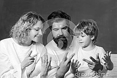 Parents encouraging their little son before the first day of school. Young happy family schooling math together. Family Stock Photo