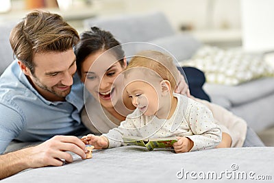 Parents enjoying with baby girl at home Stock Photo