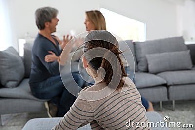 Parents fighting in front of their daughter Stock Photo