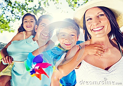 Parents Giving Their Kids A Piggy Back At Outdoors Stock Photo