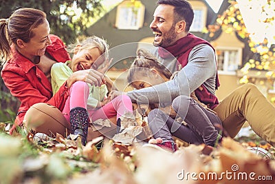 Parents have playing with children. Autumn season. Stock Photo