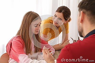 Parents helping their teenager daughter with homework Stock Photo