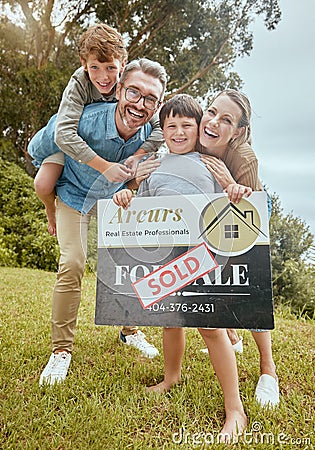 Parents, kids and property with sold sign, portrait and smile for new home, start and investment for future. Father Stock Photo