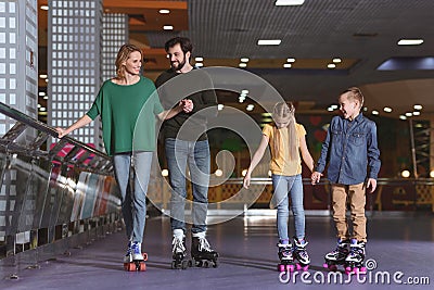 parents and kids skating on roller Stock Photo