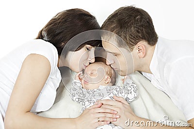 Parents kissing newborn baby Stock Photo