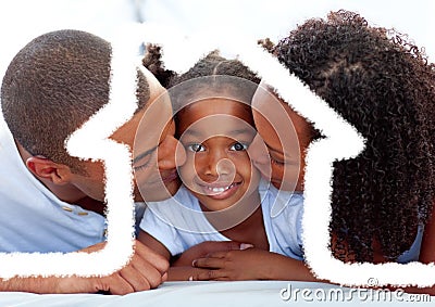 Parents kissing their daughter against house outline in background Stock Photo