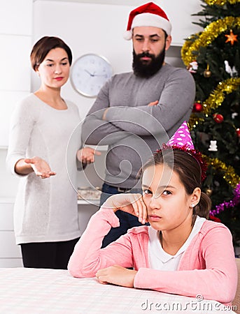Parents lecturing daughter at Christmas Stock Photo
