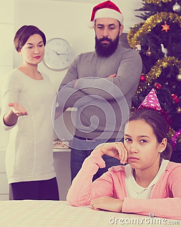 Parents lecturing daughter at Christmas Stock Photo