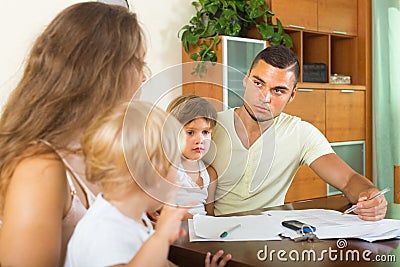 Parents and little daughters with documents Stock Photo