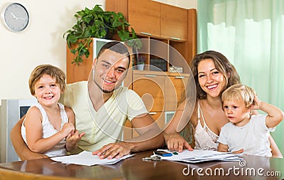 Parents and little daughters with documents Stock Photo