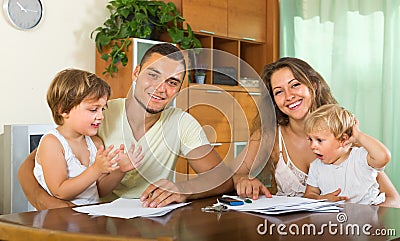 Parents and little daughters with documents Stock Photo