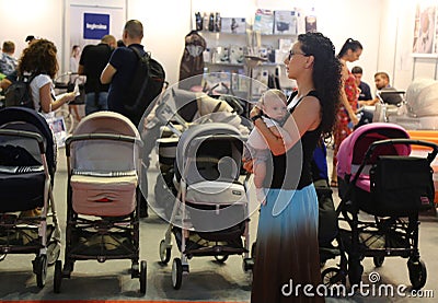 Parents looking at baby carriages Editorial Stock Photo