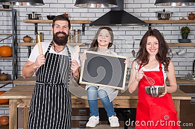 Parents mom dad and daughter chalkboard at kitchen, cook with love concept Stock Photo