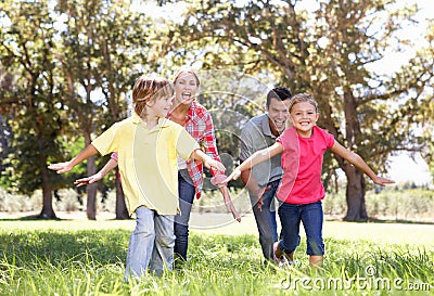 Parents playing with children in country Stock Photo