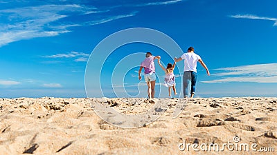 Parents Swing Child on Beach Stock Photo