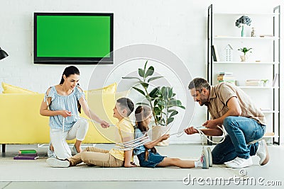 parents tying kids with rope Stock Photo