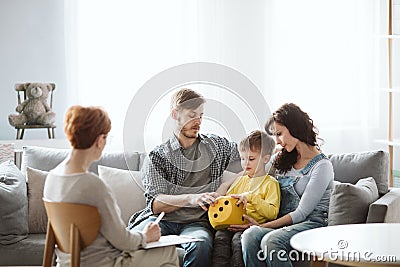 Parents work with child in therapy sessions so they learn tips and ideas for keeping up the lessons at home Stock Photo