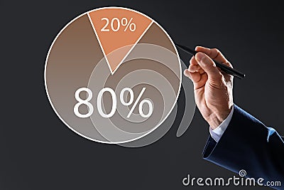 Pareto principle. Man drawing chart with 80/20 rule representation on grey background, closeup Stock Photo