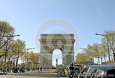 PARIS - APRIL 14, 2015: Traffic flows in the Champs Elysees on early spring, April 14, 2005 in Arc de Triomphe Paris Editorial Stock Photo