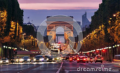 Champs-Elysees Avenue with traffic Arc de Triomphe in Paris France at night. car traffic with many cars on the street Stock Photo