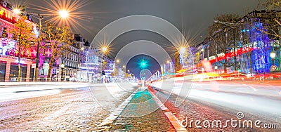 PARIS - DECEMBER 2012: Traffic along Champs Elysees at night in Editorial Stock Photo