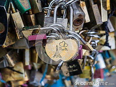 Paris engraved on love lock in closeup of love locks on Paris bridge Editorial Stock Photo