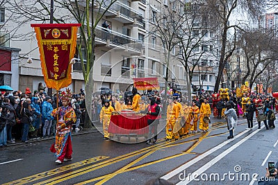 Chinese New Year, parade of dragon dance celebration the Dragon year in the thirteen district of Paris under a rain Editorial Stock Photo