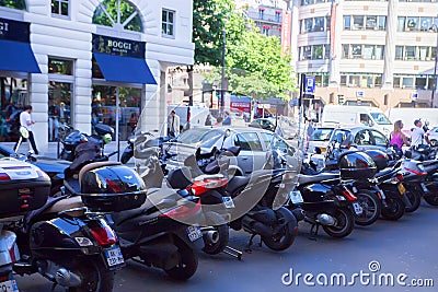 PARIS, FRANCE - CIRCA JUNE 2014: Mopeds parked in street Editorial Stock Photo