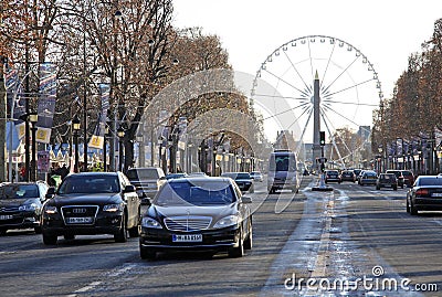 Avenue Champs-Elysees with ferris wheel at horizon in Paris, France Editorial Stock Photo