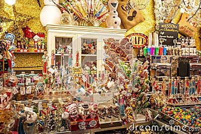 Colorful treats in traditional stalls at the Tuileries Garden Christmas Market in Paris Editorial Stock Photo