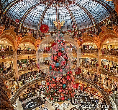 Paris, France - December 15: Massive Christmas tree decoration with flowers inside Galerie Layfayette shopping mall Editorial Stock Photo