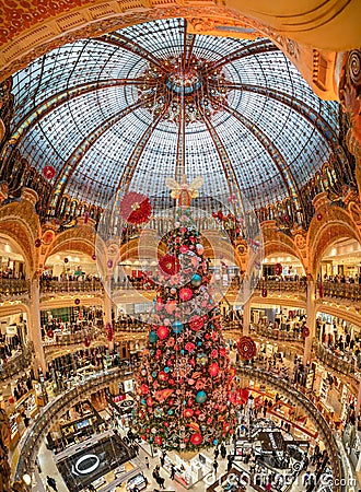 Paris, France - December 15: Massive Christmas tree decoration with flowers inside Galerie Layfayette shopping mall Editorial Stock Photo