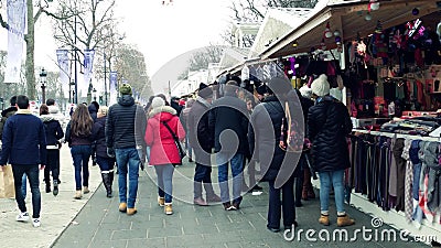 PARIS, FRANCE - DECEMBER, 31, 2016. Steadicam shot of crowded Christmas and New Year market. Souvenir stalls Editorial Stock Photo