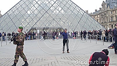 PARIS, FRANCE - DECEMBER, 31, 2016. Tourist posing and making photos near the Louvre, famous French museum, popular Editorial Stock Photo