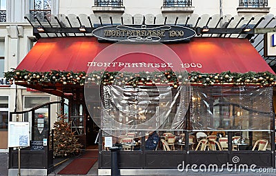 Typical Parisian restaurant Montparnasse decorated for Christmas in the heart of Paris. Christmas is one of the main Editorial Stock Photo