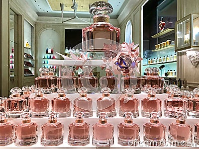 Group of elegant bottles of perfume in a Guerlain perfumery shop window Editorial Stock Photo