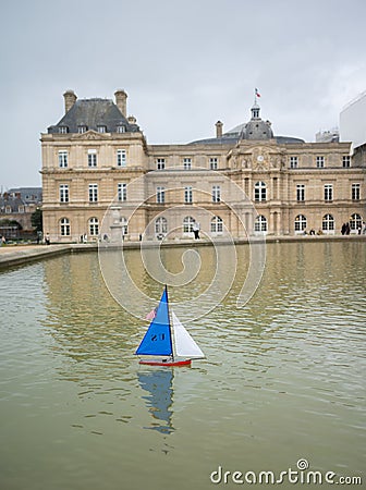 Paris France February 4, 20232: Les Voiliers du Luxembourg. A remote control boat in a fountain in front of the Luxembourg Palace Editorial Stock Photo