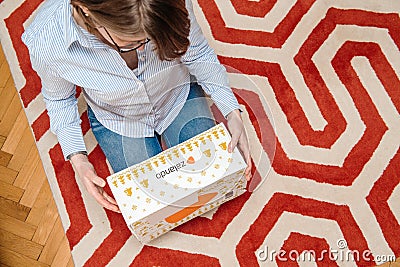 Woman unpacking parcel from Zalando fashion store Editorial Stock Photo