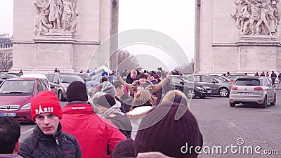 PARIS, FRANCE - JANUARY, 1, 2017. Multinational tourists making photos near famous triumphal arch, Arc de Triomphe Editorial Stock Photo