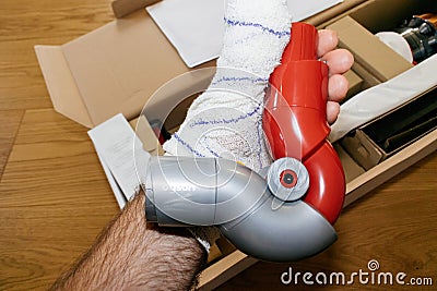 hand holding during unpacking new Up-Top-adaptor for modern wire Editorial Stock Photo